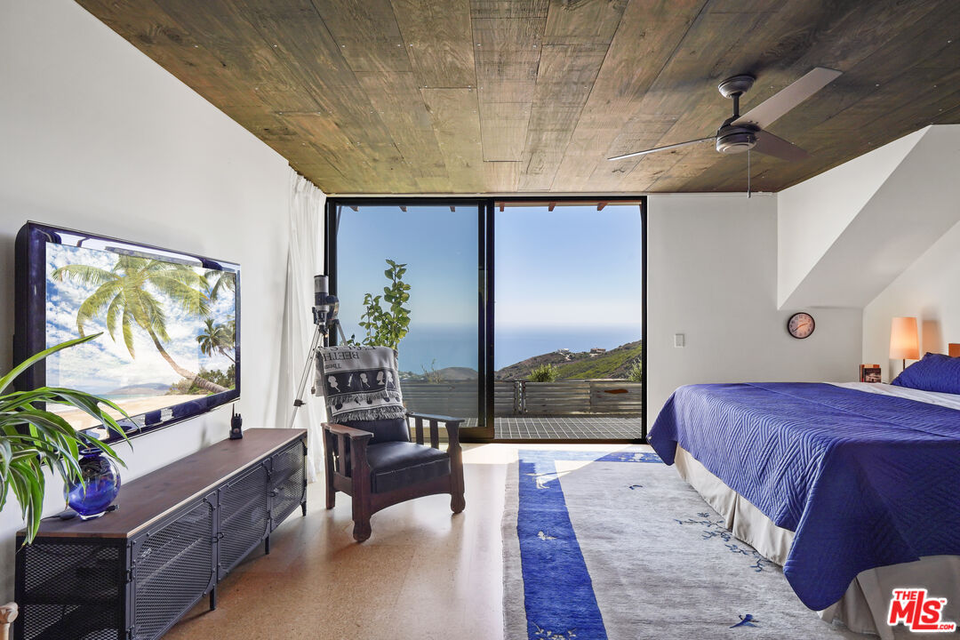 26335 Lockwood Road Malibu, CA 90265 - Photo 14 of 39 a living room with a bed furniture and a flat screen tv