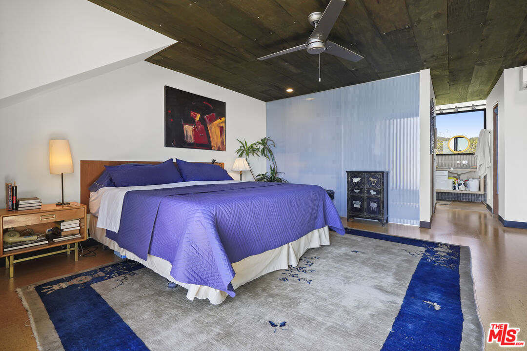 26335 Lockwood Road Malibu, CA 90265 - Photo 15 of 39 a spacious bedroom with a bed and a view of kitchen