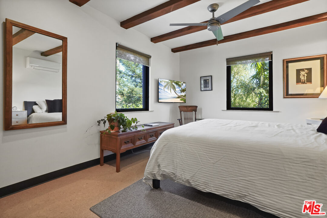 26335 Lockwood Road Malibu, CA 90265 - Photo 19 of 39 a bedroom with a bed and windows