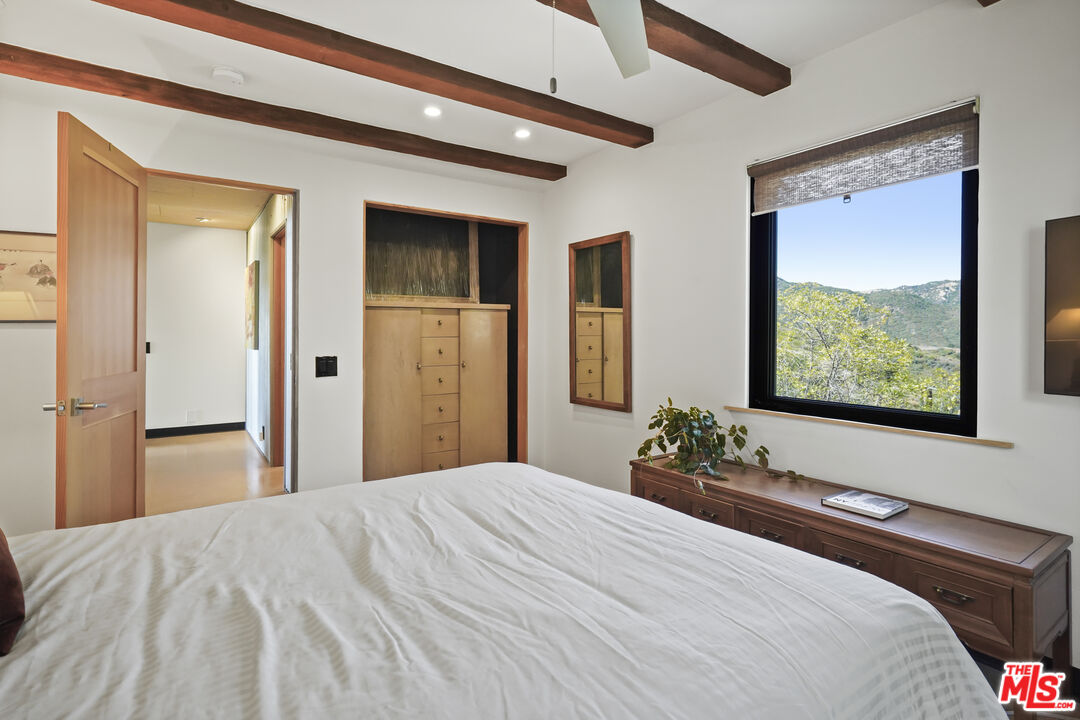 26335 Lockwood Road Malibu, CA 90265 - Photo 20 of 39 a bedroom with a bed and a large window