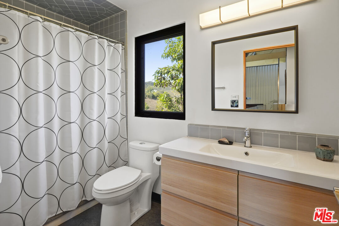 26335 Lockwood Road Malibu, CA 90265 - Photo 21 of 39 a bathroom with a toilet sink and mirror