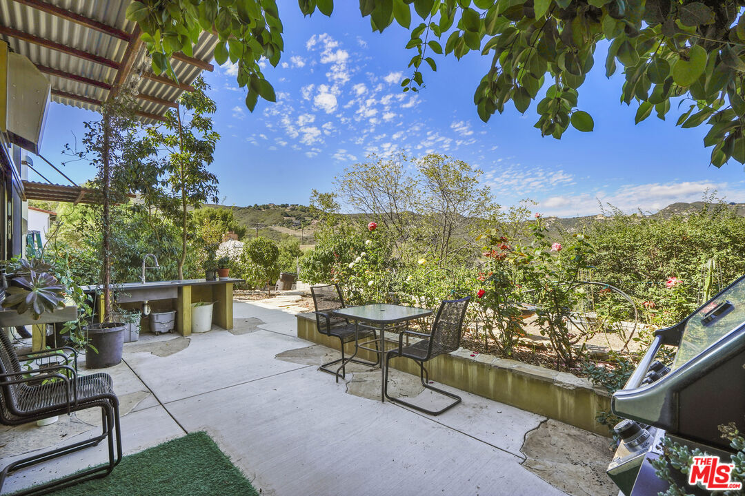 26335 Lockwood Road Malibu, CA 90265 - Photo 33 of 39 a view of a chairs and table in a patio