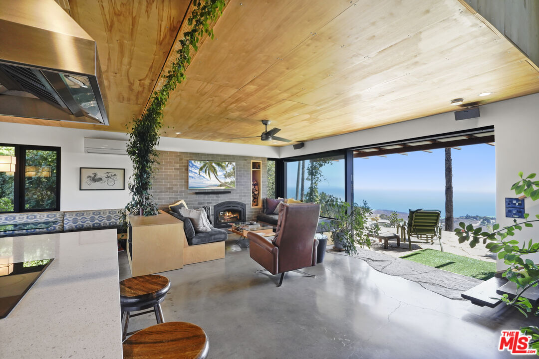 26335 Lockwood Road Malibu, CA 90265 - Photo 5 of 39 a living room with furniture and a chandelier