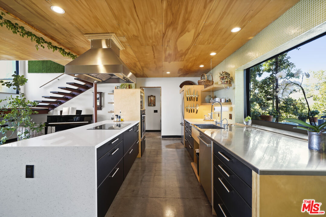26335 Lockwood Road Malibu, CA 90265 - Photo 8 of 39 a large kitchen with stainless steel appliances a large counter top