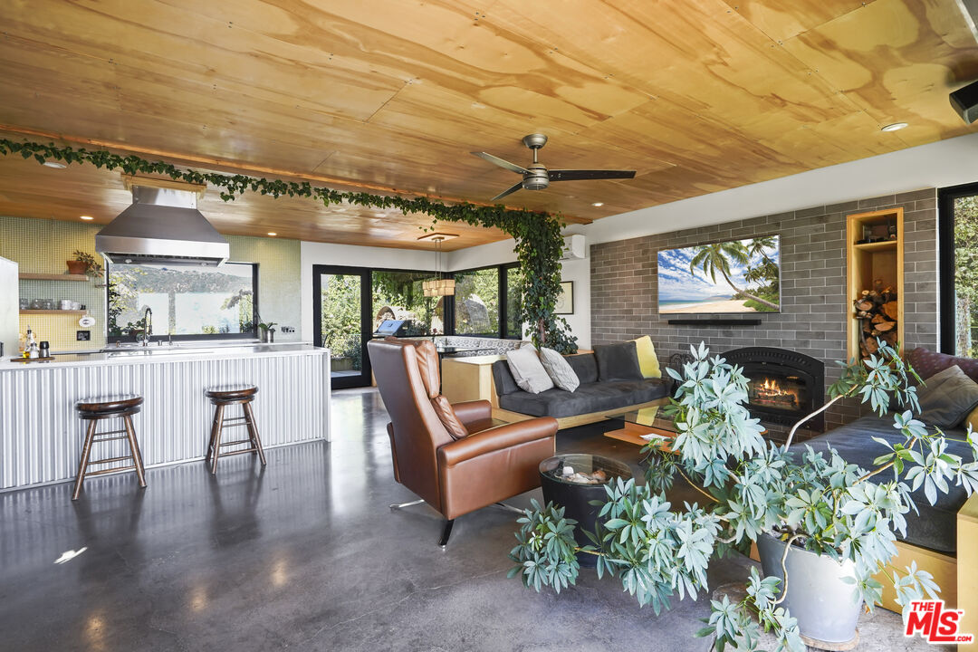 26335 Lockwood Road Malibu, CA 90265 - Photo 10 of 39 a living room with furniture and a large window