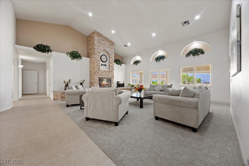 640 Quail Covey Road Henderson, NV 89002 - Photo 8 of 75 Living room with high vaulted ceiling, a stone fireplace, tile patterned floors, and recessed lighting
