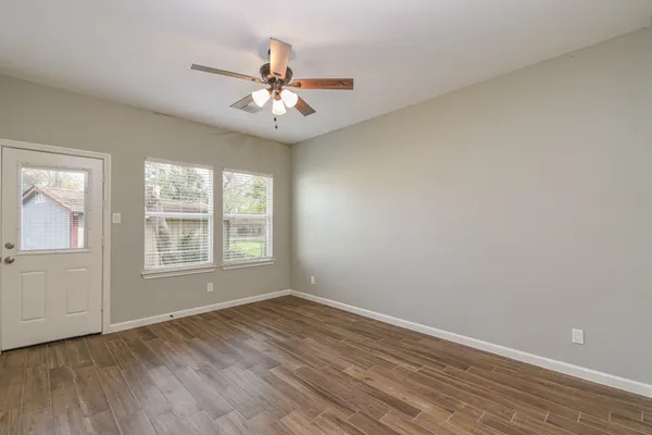 wooden floor in an empty room with a window