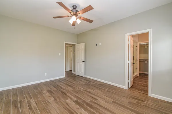 a view of an empty room with wooden floor