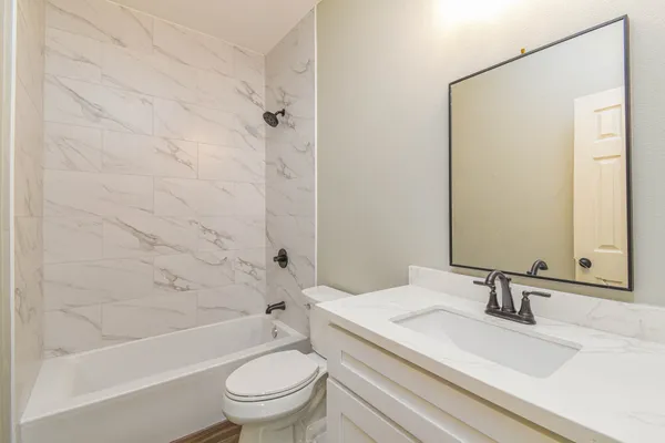 a bathroom with a sink a toilet and a bathtub