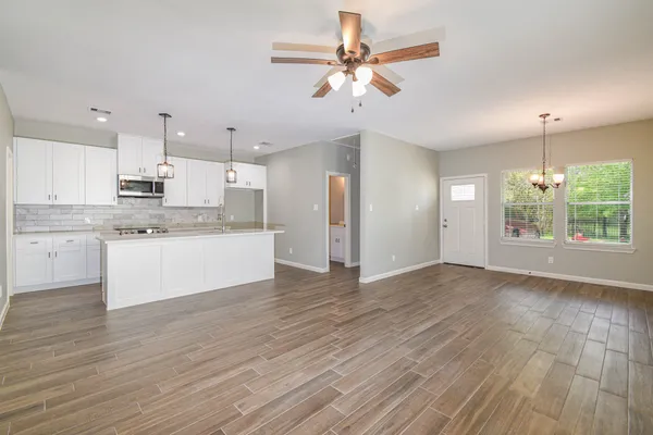 a view of kitchen with granite countertop cabinets and outdoor space