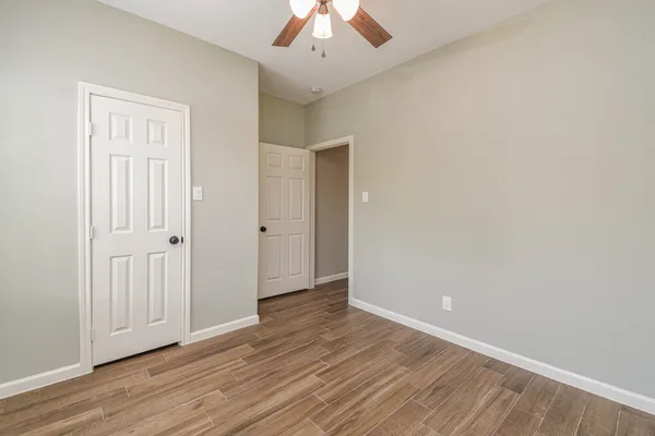 wooden floor in an empty room with a window