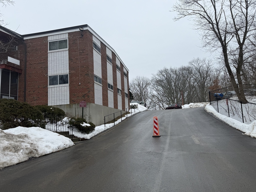 115 Grove Street, Unit 1 Boston, MA 02132 - Photo 14 of 15 a street view along with residential houses