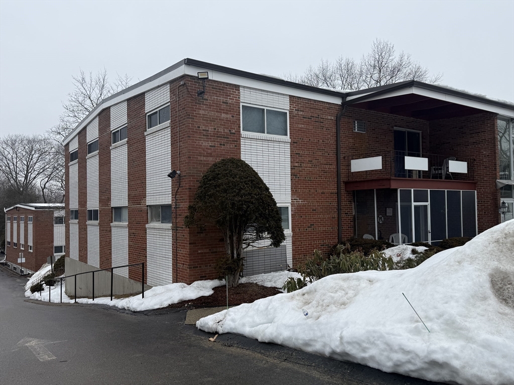 115 Grove Street, Unit 1 Boston, MA 02132 - Photo 2 of 15 a front view of a house with a yard