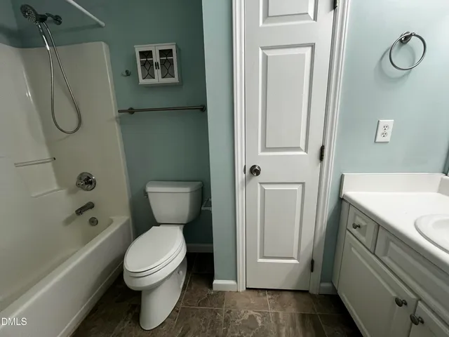 a bathroom with a toilet sink and shower