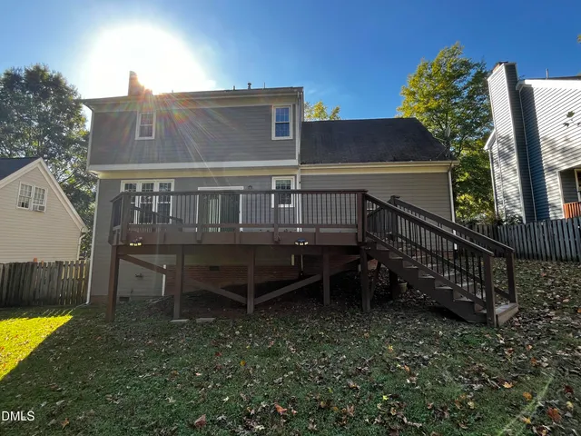 a view of a house with a yard and furniture