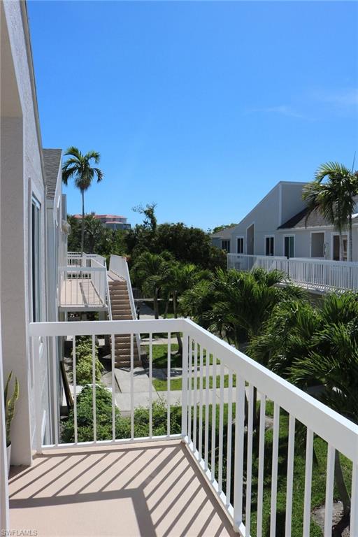 2235 San Marco Road, Unit 5204 Marco Island, FL 34145 - Photo 11 of 34 Private balcony with white railing overlooking tropical landscaping