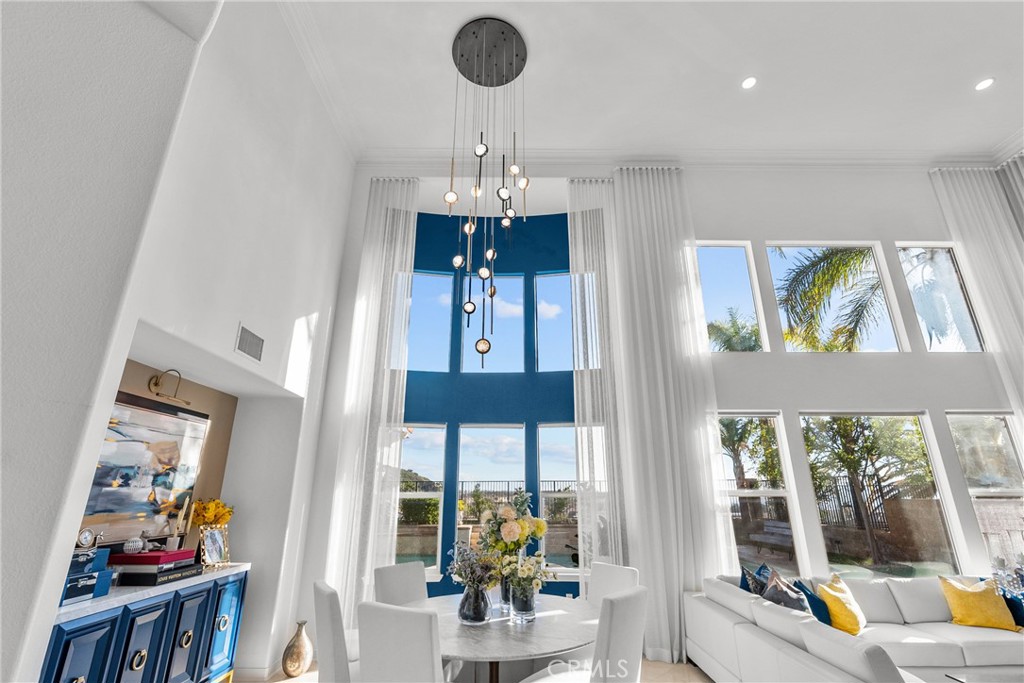 20366 Vía Galileo Porter Ranch, CA 91326 - Photo 24 of 75 a view of a dining room with furniture a chandelier and wooden floor