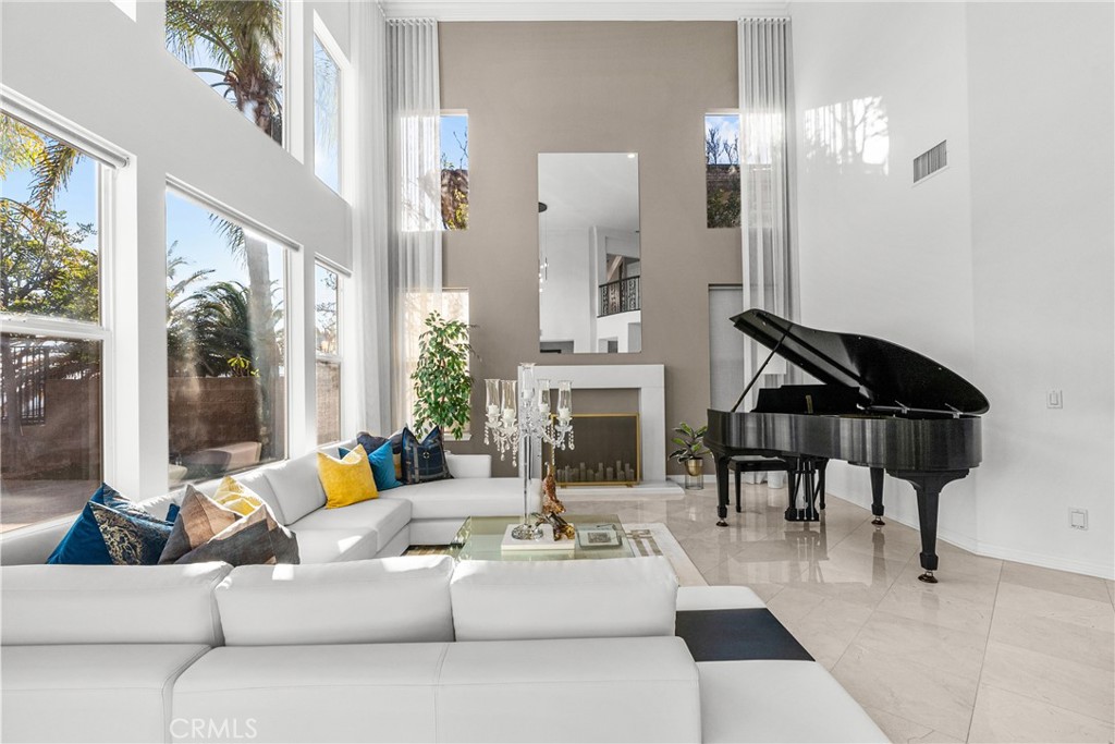 20366 Vía Galileo Porter Ranch, CA 91326 - Photo 26 of 75 a living room with furniture a fireplace and a chandelier