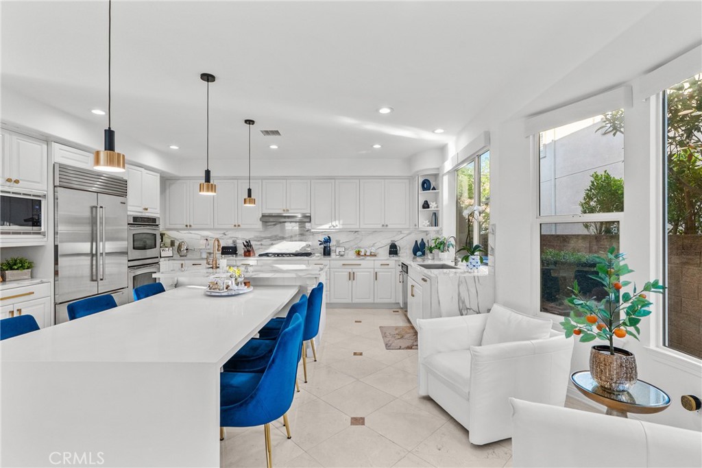 20366 Vía Galileo Porter Ranch, CA 91326 - Photo 35 of 75 a kitchen with stainless steel appliances kitchen island granite countertop a sink a stove and a refrigerator