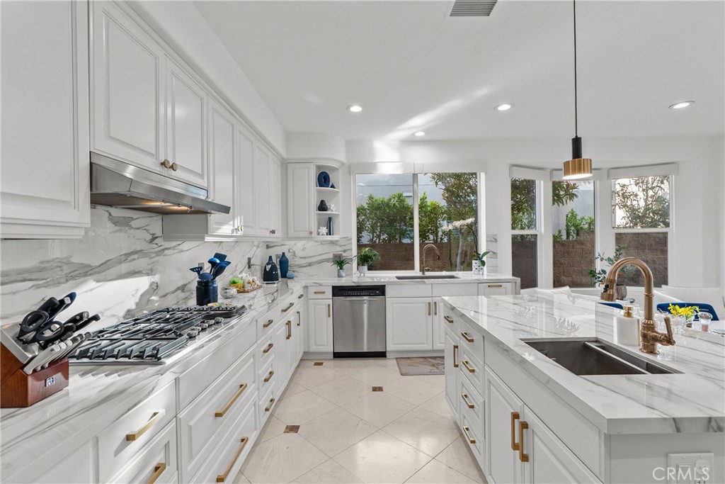 20366 Vía Galileo Porter Ranch, CA 91326 - Photo 37 of 75 a kitchen with a sink stove and cabinets