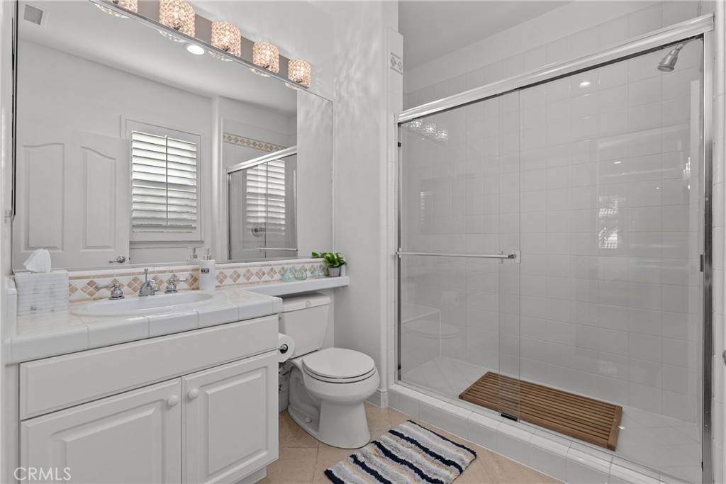 20366 Vía Galileo Porter Ranch, CA 91326 - Photo 54 of 75 a bathroom with a sink a toilet a mirror and a shower