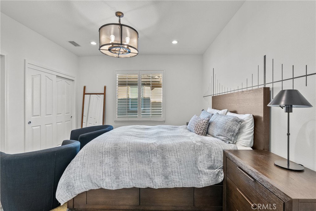 20366 Vía Galileo Porter Ranch, CA 91326 - Photo 58 of 75 a bedroom with a bed and a chandelier