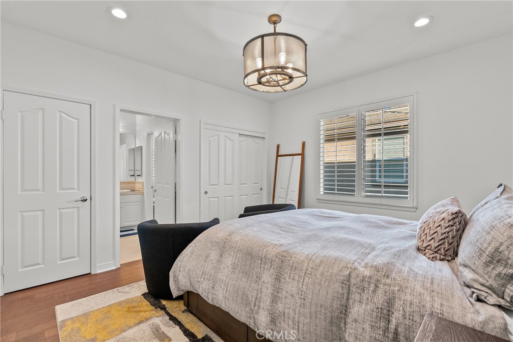 20366 Vía Galileo Porter Ranch, CA 91326 - Photo 59 of 75 a bedroom with a bed and a chandelier