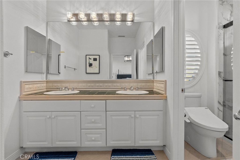 20366 Vía Galileo Porter Ranch, CA 91326 - Photo 60 of 75 a bathroom with a sink a toilet and a mirror