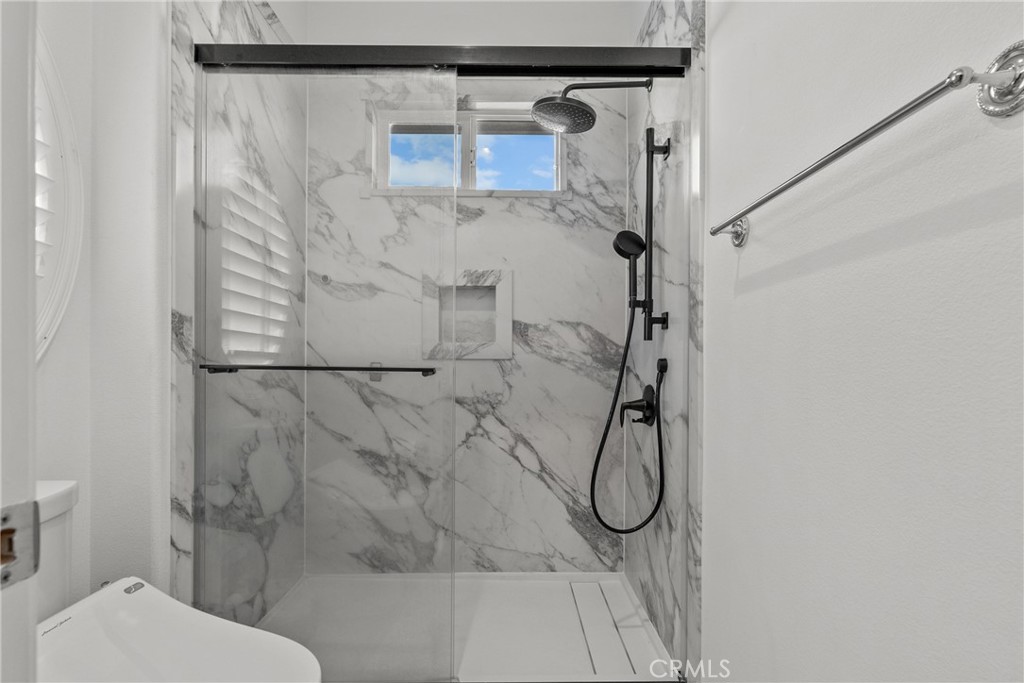 20366 Vía Galileo Porter Ranch, CA 91326 - Photo 61 of 75 a bathroom with a granite countertop shower and a toilet