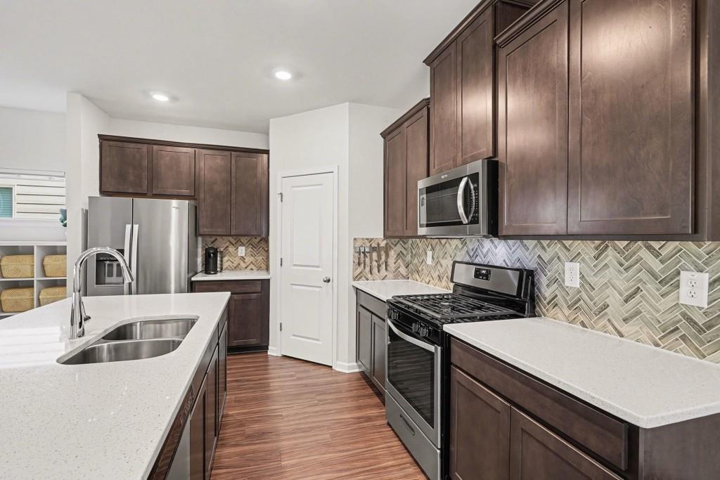 4740 Electric Avenue Southwest Mableton, GA 30126 - Photo 15 of 51 a kitchen that has a sink cabinets and stainless steel appliances