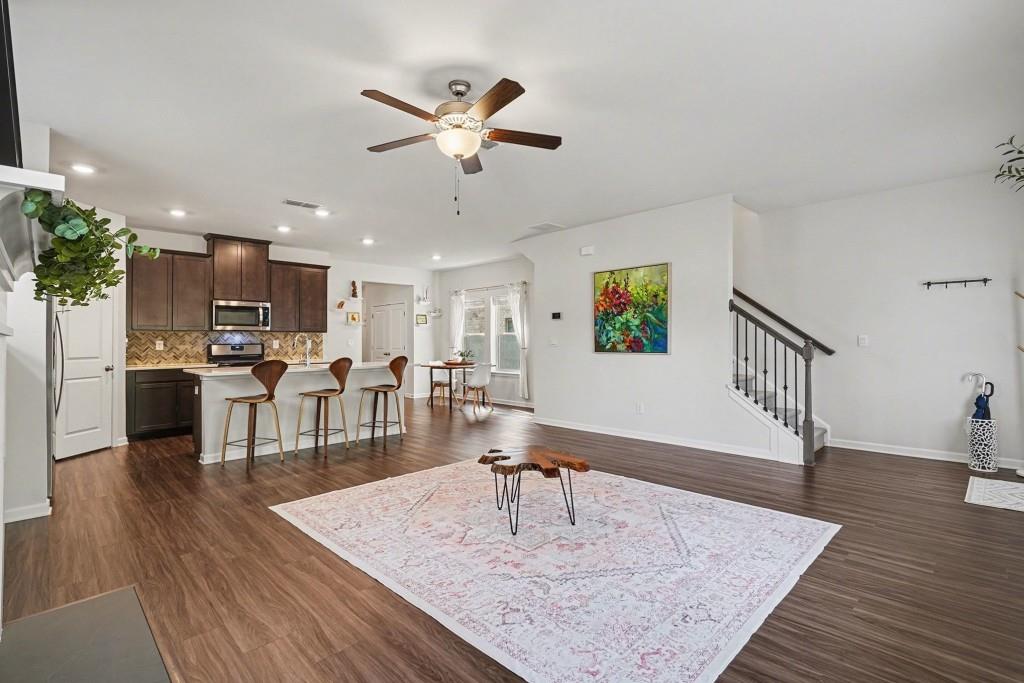 4740 Electric Avenue Southwest Mableton, GA 30126 - Photo 16 of 51 a living room with couches chairs and kitchen view with wooden floor
