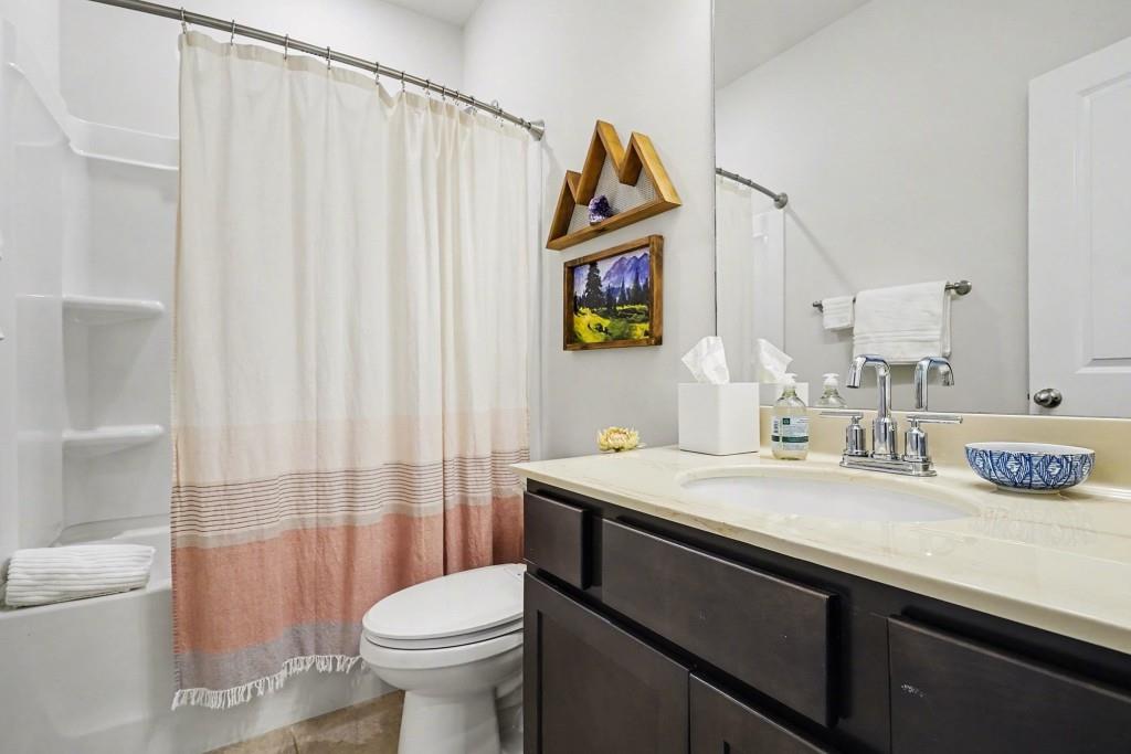 4740 Electric Avenue Southwest Mableton, GA 30126 - Photo 21 of 51 a bathroom with a sink a toilet and a mirror