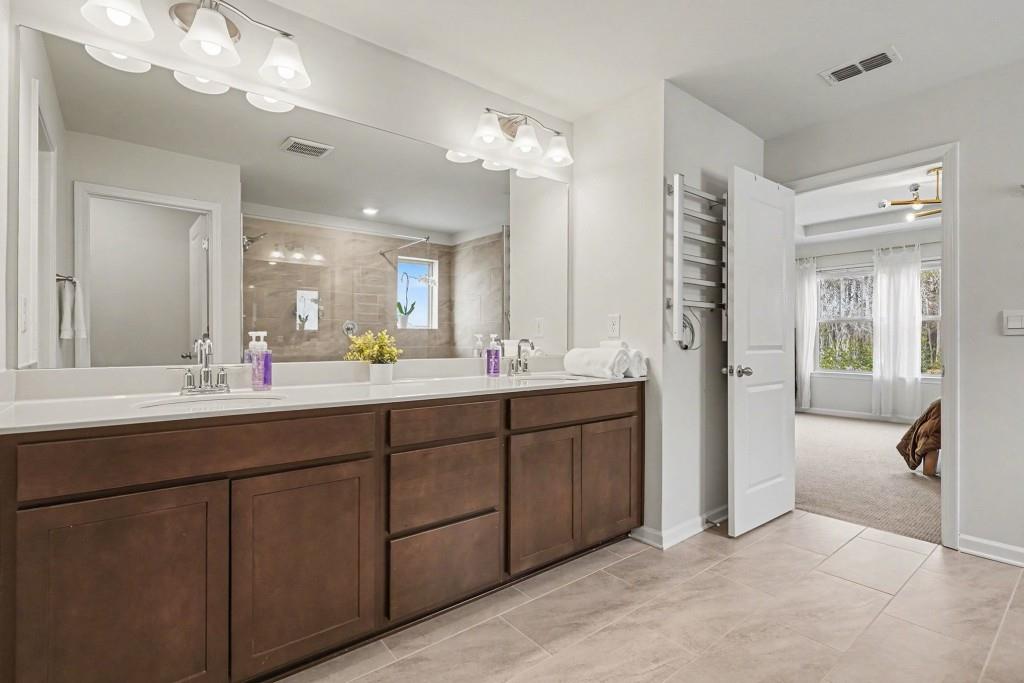 4740 Electric Avenue Southwest Mableton, GA 30126 - Photo 27 of 51 a bathroom with a double vanity sink and a mirror