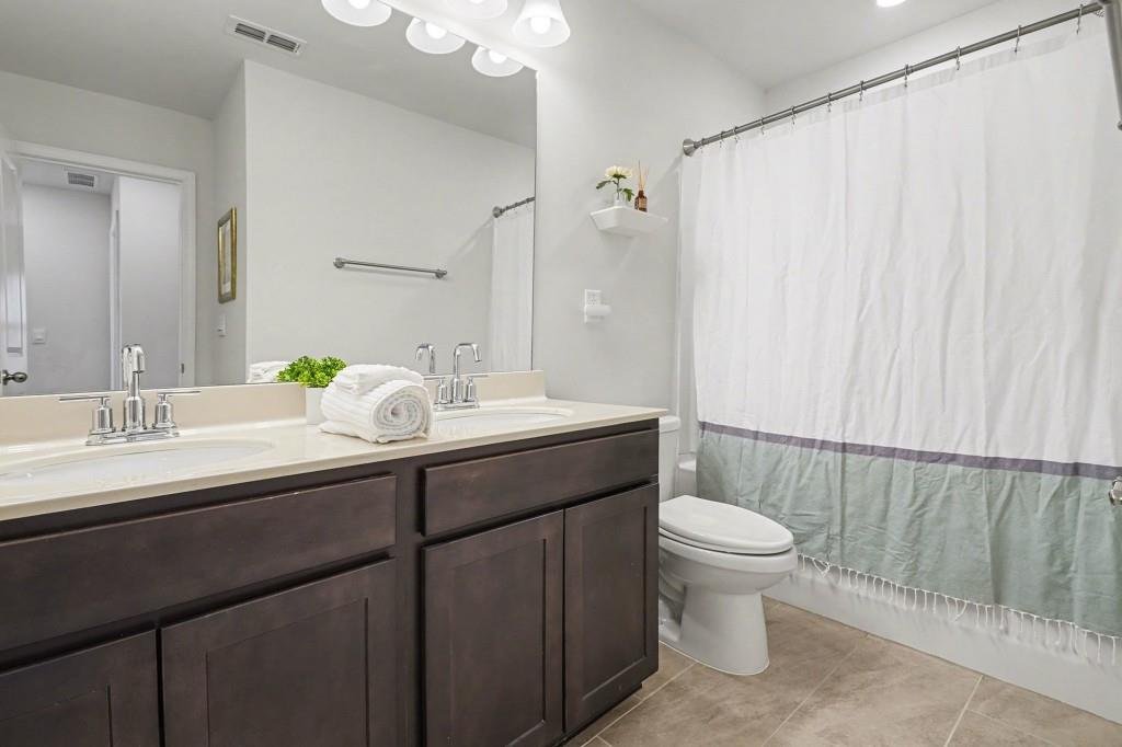 4740 Electric Avenue Southwest Mableton, GA 30126 - Photo 35 of 51 a bathroom with a double vanity sink toilet and a mirror