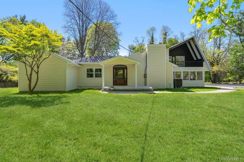497 Woodbury Road Cold Spring Harbor, NY 11724 - Photo 2 of 24 a front view of house with yard and green space