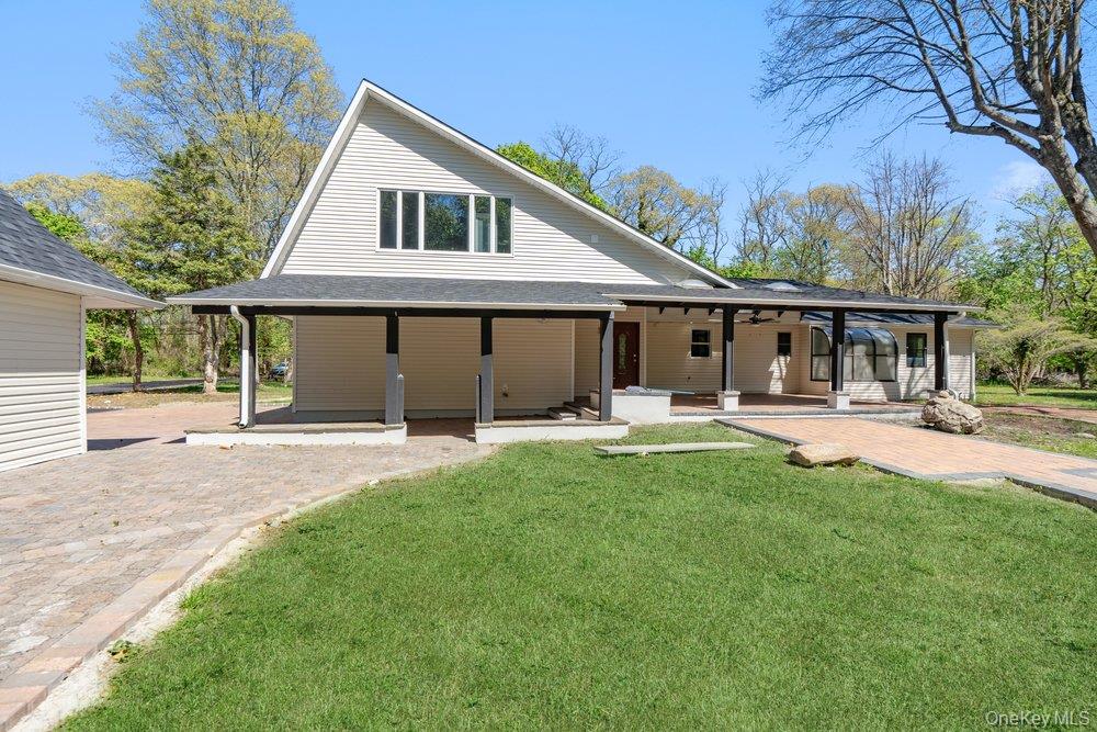 497 Woodbury Road Cold Spring Harbor, NY 11724 - Photo 24 of 24 a front view of a house with yard patio and green space