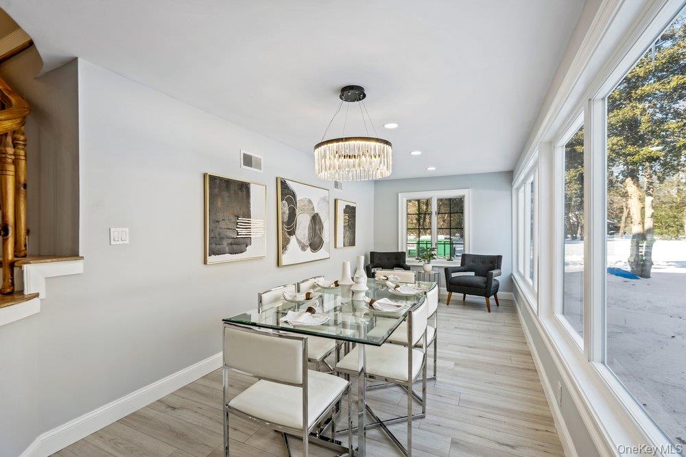 497 Woodbury Road Cold Spring Harbor, NY 11724 - Photo 4 of 24 a living room with furniture and a large window