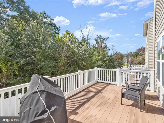 a view of a chair and table on the deck