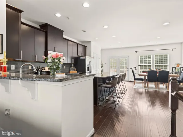 a kitchen with counter space dining table and chairs