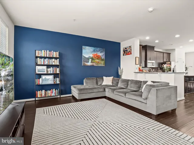 a living room with furniture and a book shelf