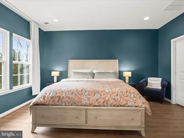 a bedroom with a bed and a large window