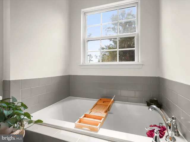 a bath tub sitting in a bathroom next to a window