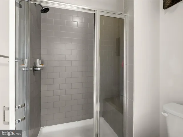 a bathroom with a glass shower door