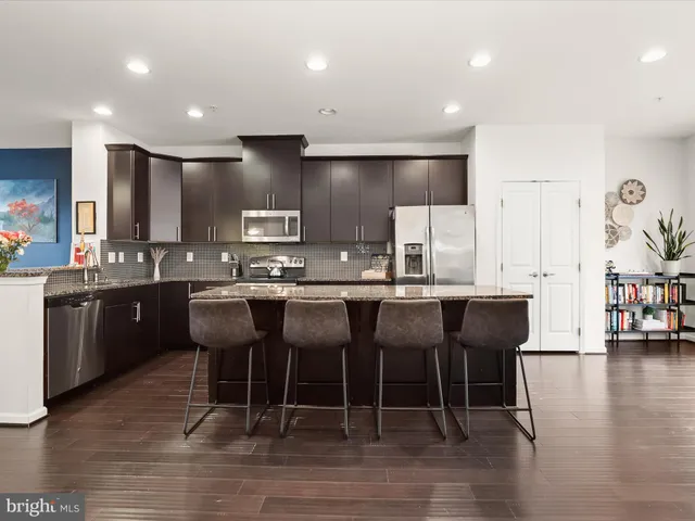 a large kitchen with a table and chairs
