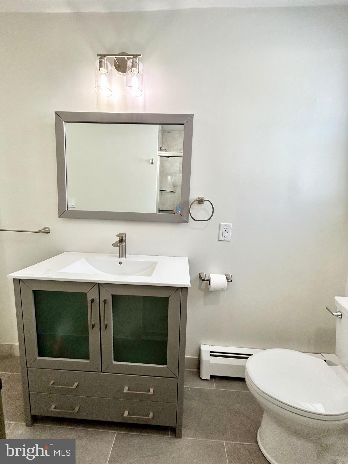1007 Ripley Street Philadelphia, PA 19111 - Photo 13 of 39 a bathroom with a sink toilet and mirror