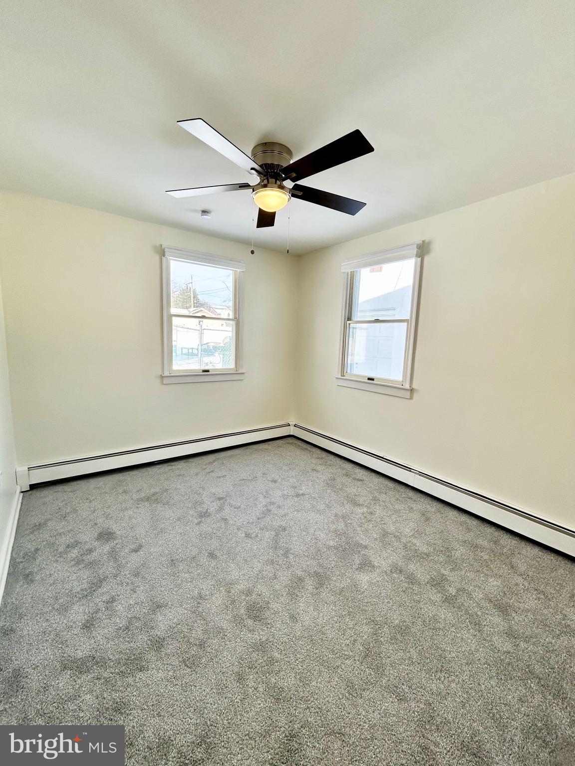 1007 Ripley Street Philadelphia, PA 19111 - Photo 17 of 39 an empty room with windows and ceiling fan