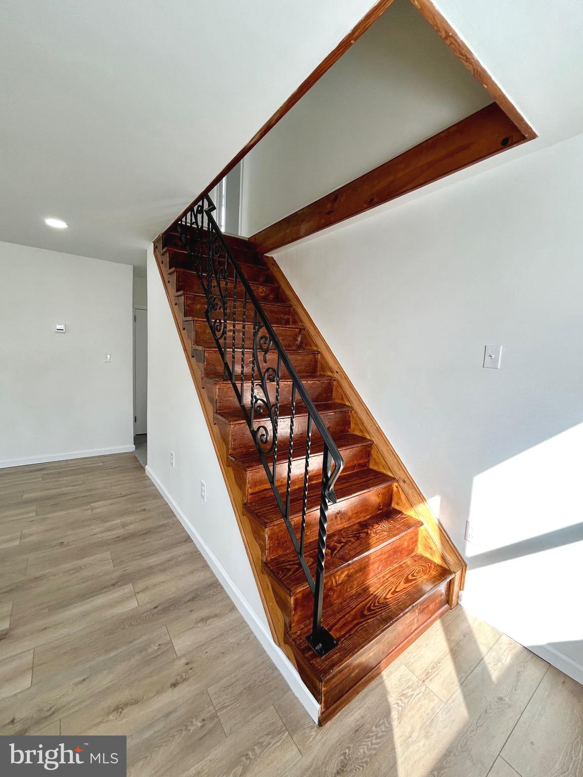 1007 Ripley Street Philadelphia, PA 19111 - Photo 21 of 39 a view of staircase with white walls and a black umbrella