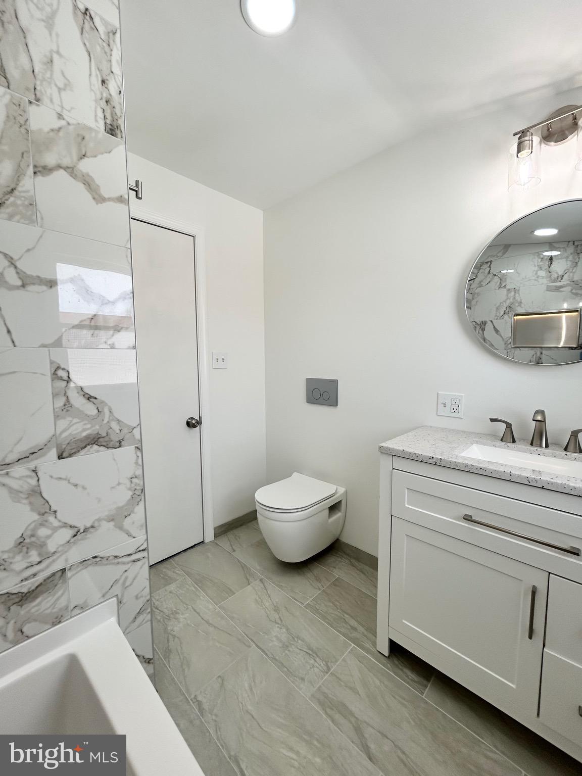 1007 Ripley Street Philadelphia, PA 19111 - Photo 26 of 39 a bathroom with a granite countertop sink mirror and toilet