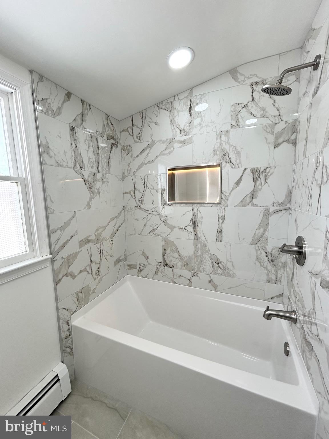 1007 Ripley Street Philadelphia, PA 19111 - Photo 27 of 39 a bathroom with a bathtub and a shower