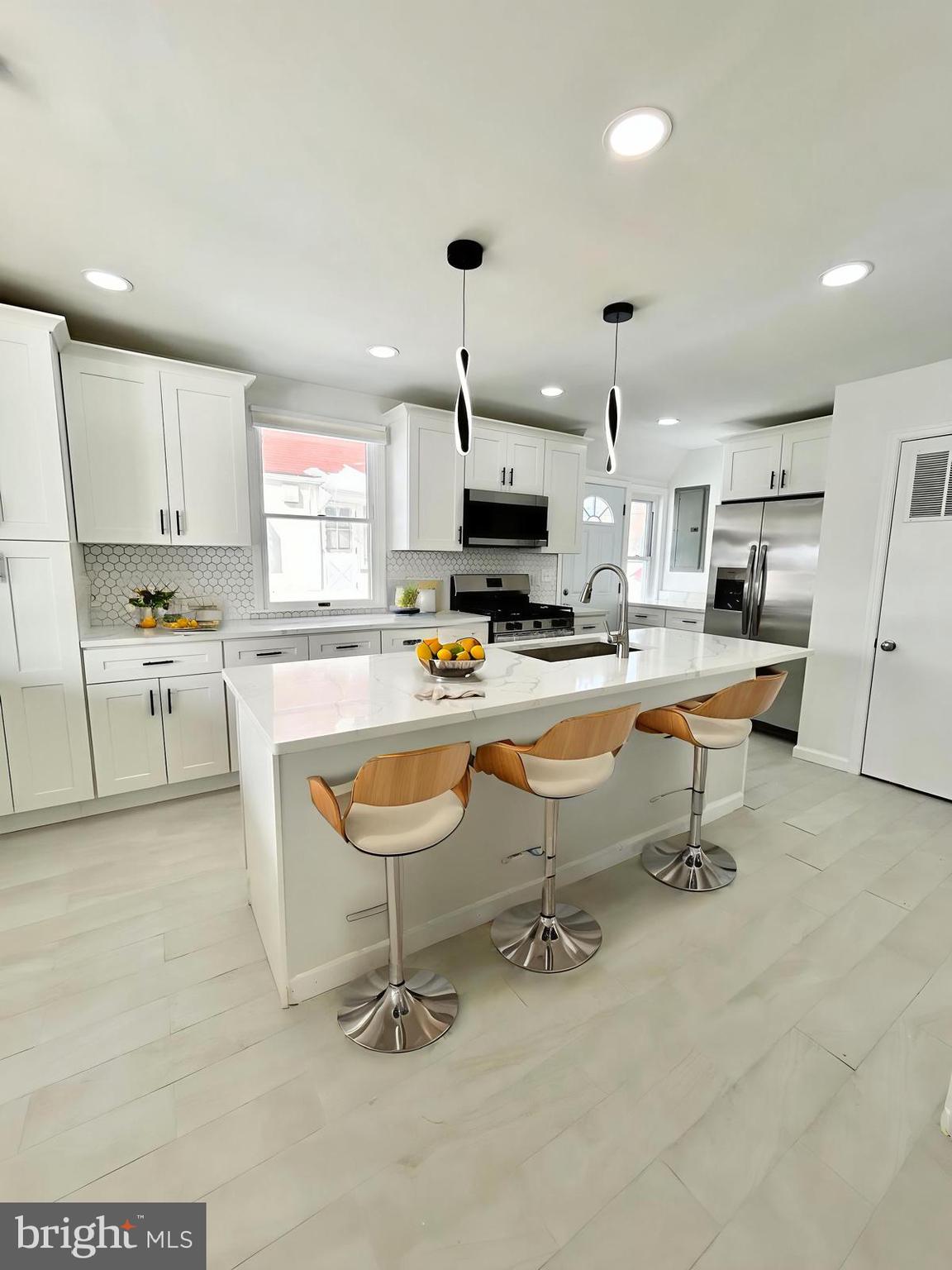1007 Ripley Street Philadelphia, PA 19111 - Photo 5 of 39 a living room with stainless steel appliances kitchen island furniture and a fireplace